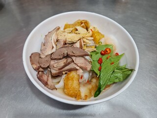 Banh uot long ga, a Vietnamese cuisine. Mixed batter is steamed to become a thin layer, then cut into small pieces. Then mixed them with boiled chicken organs, unlaid eggs. Eat with ginger fish sauce