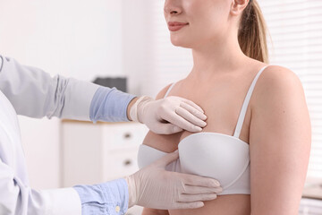 Fototapeta na wymiar Mammologist checking woman's breast in hospital, closeup