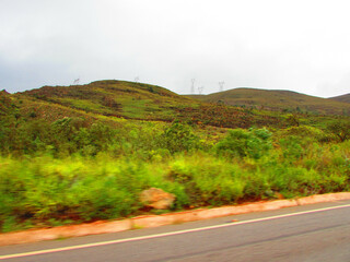 A beautiful landscape and view of a beautiful mountain next to a road