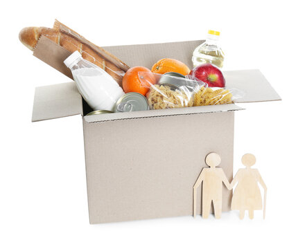 Humanitarian aid for elderly people. Cardboard box with donation food and wooden figures of couple isolated on white