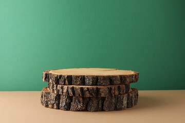 Presentation for product. Wooden stumps on color background. Space for text