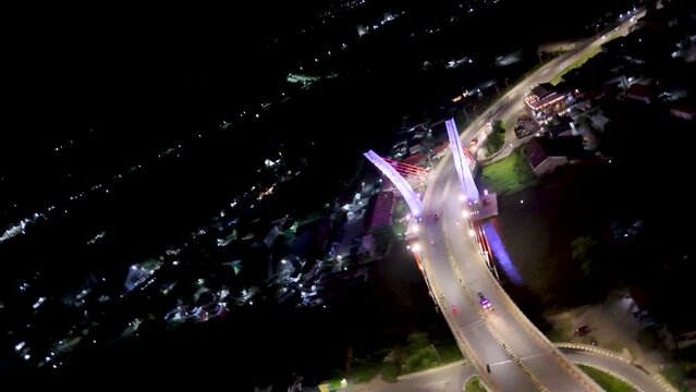 View of the Banjarmasin city and Alalak River Bridge or Basit Bridge from a drone during the night