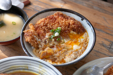 Close up homemade Katsudon serve on wood table