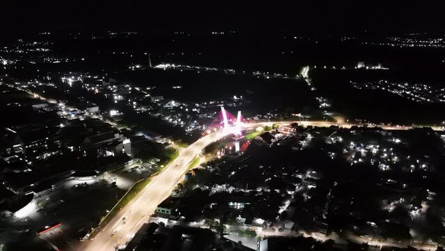 View of the Banjarmasin city and Alalak River Bridge or Basit Bridge from a drone during the night
