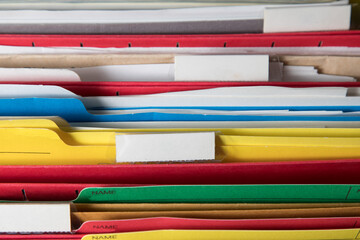 closeup of file folders in an open filing cabinet with blank labels