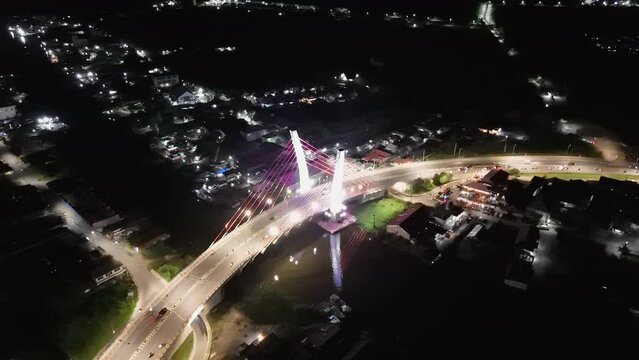 View of the Banjarmasin city and Alalak River Bridge or Basit Bridge from a drone during the night