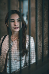Beautiful young Asian brunette woman wearing fashion clothes casual dress. Portrait fashion model at traditional architecture old wall vintage building. Retro style.