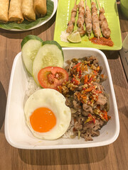 rice bowl, grilled beef belly with spices, served with rice and sunny side up egg.