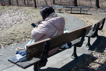 Woman on a park looking at the phone