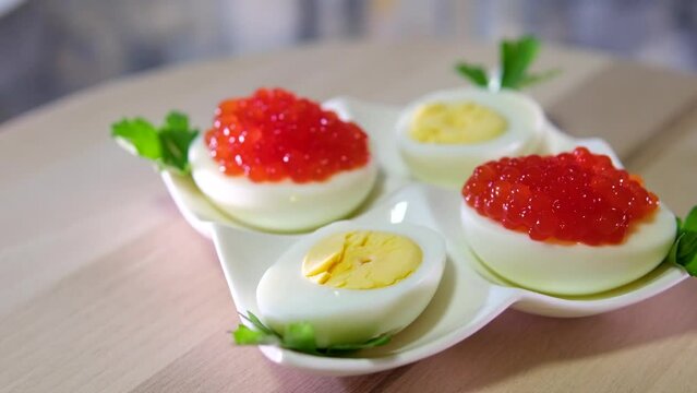 Black and red fish roe Caviar served on boiled eggs Eggs with red caviar on a plate serving irestaurant