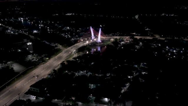 View of the Banjarmasin city and Alalak River Bridge or Basit Bridge from a drone during the night