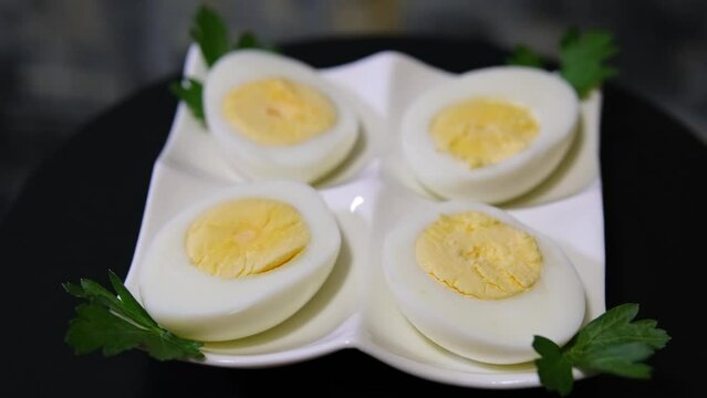 Boiled eggs for breakfast. On a white plate. Black background
