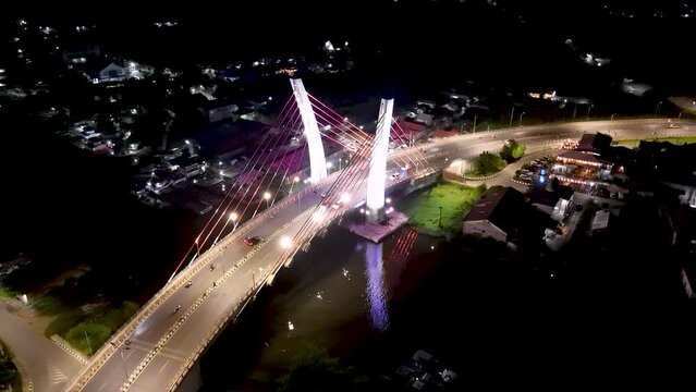 View of the Banjarmasin city and Alalak River Bridge or Basit Bridge from a drone during the night