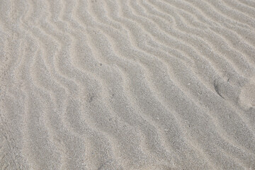 beach sand surface texture, abstract background, natural pattern.