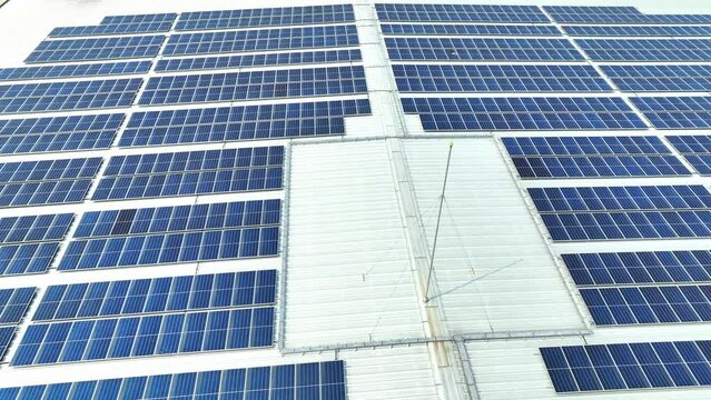 A rooftop adorned with orderly arrays of azure solar panels, interspersed with patches of unclad space, a harmonious marriage of tech and structure. Solar panels background.
