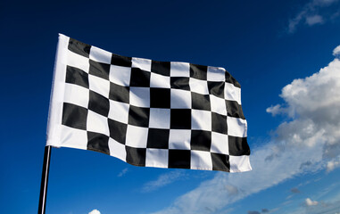Checkered flag on blue sky