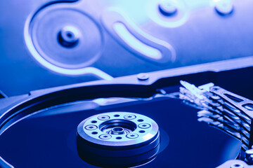 computer hard drive against opened disc cover. blue toned image. - 784216221