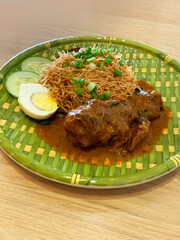 traditional peranakan wok fried nonya mee siam noodle spicy chilli shrimp paste w chicken rendang curry egg sambal cucumber in bamboo plate asian cafe hotel luxury halal food restaurant banquet menu