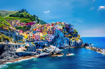 Foto auf Acrylglas Ligurien A colorful Italian village on the cliffs of Cinque Terre overlooking the blue sea