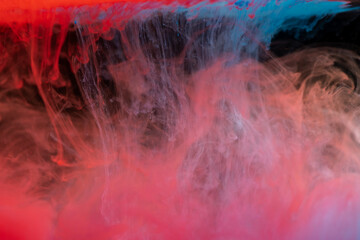 clouds of red and blue smoke on black background, clouds of paint in water, aquarium, abstract...