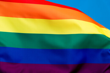 Obraz premium Rainbow flag waving on blue background