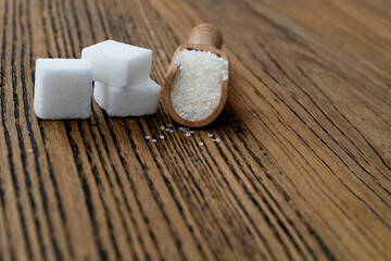 Sugar cubes and sugar crystals in scoop