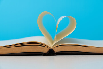 Book pages curved into heart shape