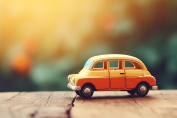 Miniature yellow retro style toy car on blurred background