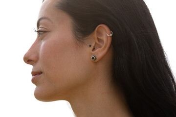 A profile portrait of a young woman showing an ear