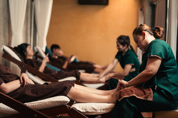 Professional Masseuse mature asian woman working service foot massage to customer in spa salon,...