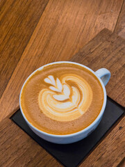 Nice Texture of Latte art on hot latte coffee . Milk foam in heart shape leaf tree on top of latte art from professional barista artist. - 784243474