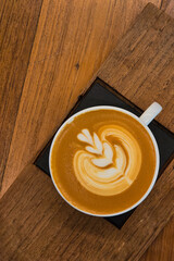 Nice Texture of Latte art on hot latte coffee . Milk foam in heart shape leaf tree on top of latte art from professional barista artist. - 784243478