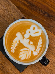 Nice Texture of Latte art on hot latte coffee . Milk foam in heart shape leaf tree on top of latte art from professional barista artist. - 784243479