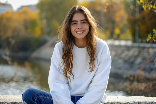 Young beautiful girl in a white sweatshirt.