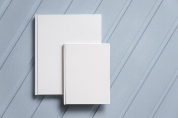 two books with blank white covers, a paper album mockup. background, hardcover. mockup, an empty space for your text. top view, flat layout.
