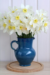 garden daffodils in a jug on the table in the cottage, a spring still life with flowers.