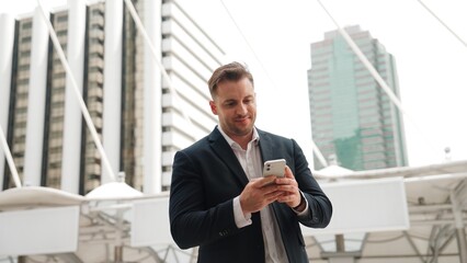 Caucasian business man checking mobile phone and looking report sales from marketing team while...