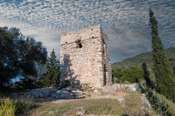 Ruins of an old tower in the Hymettus mountain at Athens-Greece. Nice cloudy sky at the background.