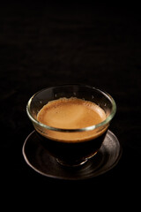 Cup of espresso on black background. Copy space.
