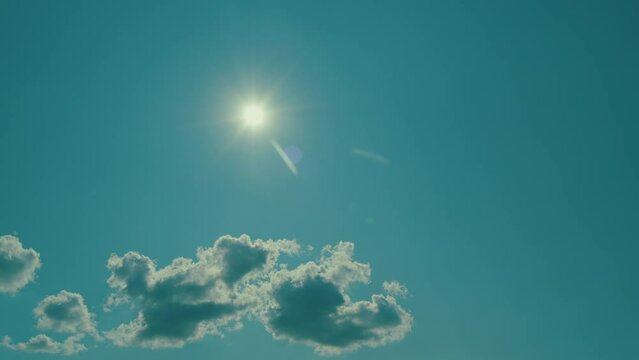 Bright Blue Sky And Sun Flare In Spring Sky With Clouds Vapor. Sun Shining With Clouds.