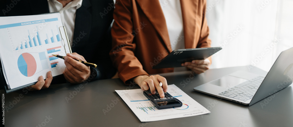 Poster business documents on office table with smart phone and calculator digital tablet and graph business