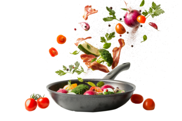 Vegetables fall into a black frying pan on a transparent background. Healthy food concept