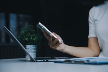 Excited happy Asian woman looking at the phone screen, celebrating an online win, overjoyed young asian female screaming with joy, isolated over a white blur background
