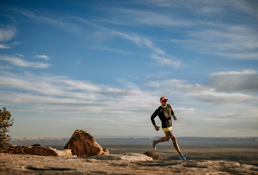 caucasian male runs through stark barren desert, Utah