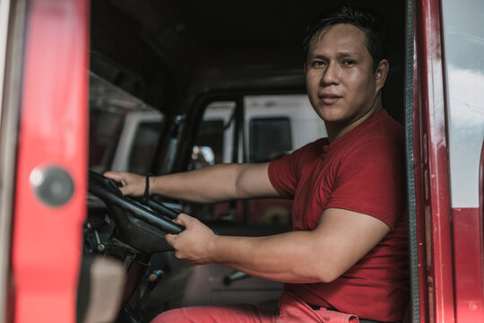 Portrait of fire truck driver smiling at fire station