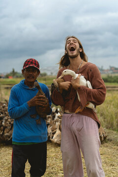 European man with local Indonesian farmer.