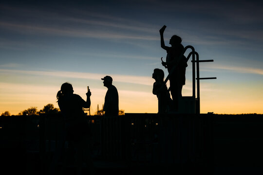 Silhouette of family watching total solar eclipse in sunset