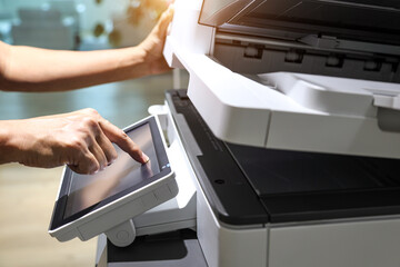 Hand use copier or photocopier or photocopy machine office equipment workplace for scanner or scanning document or printer for printing paperwork hard copy duplicate Xerox service maintenance repair. - obrazy, fototapety, plakaty
