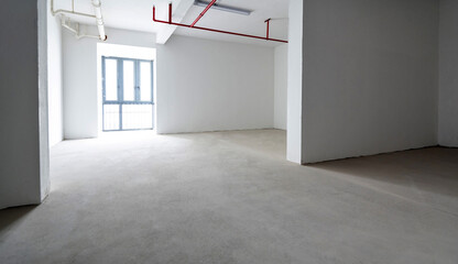 Room with white walls and cement floor
