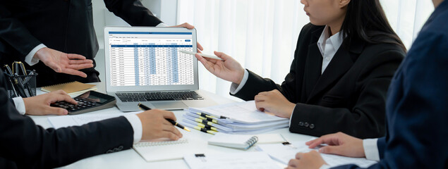 Corporate accountant team use accounting software on laptop to calculate and maximize tax refund...
